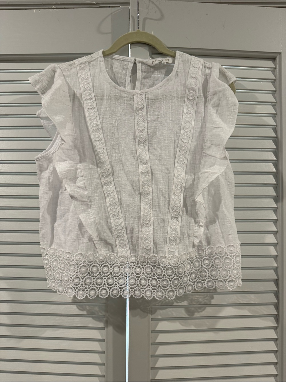 Apricot White Eyelet Trim Ruffled Sleeveless Top
